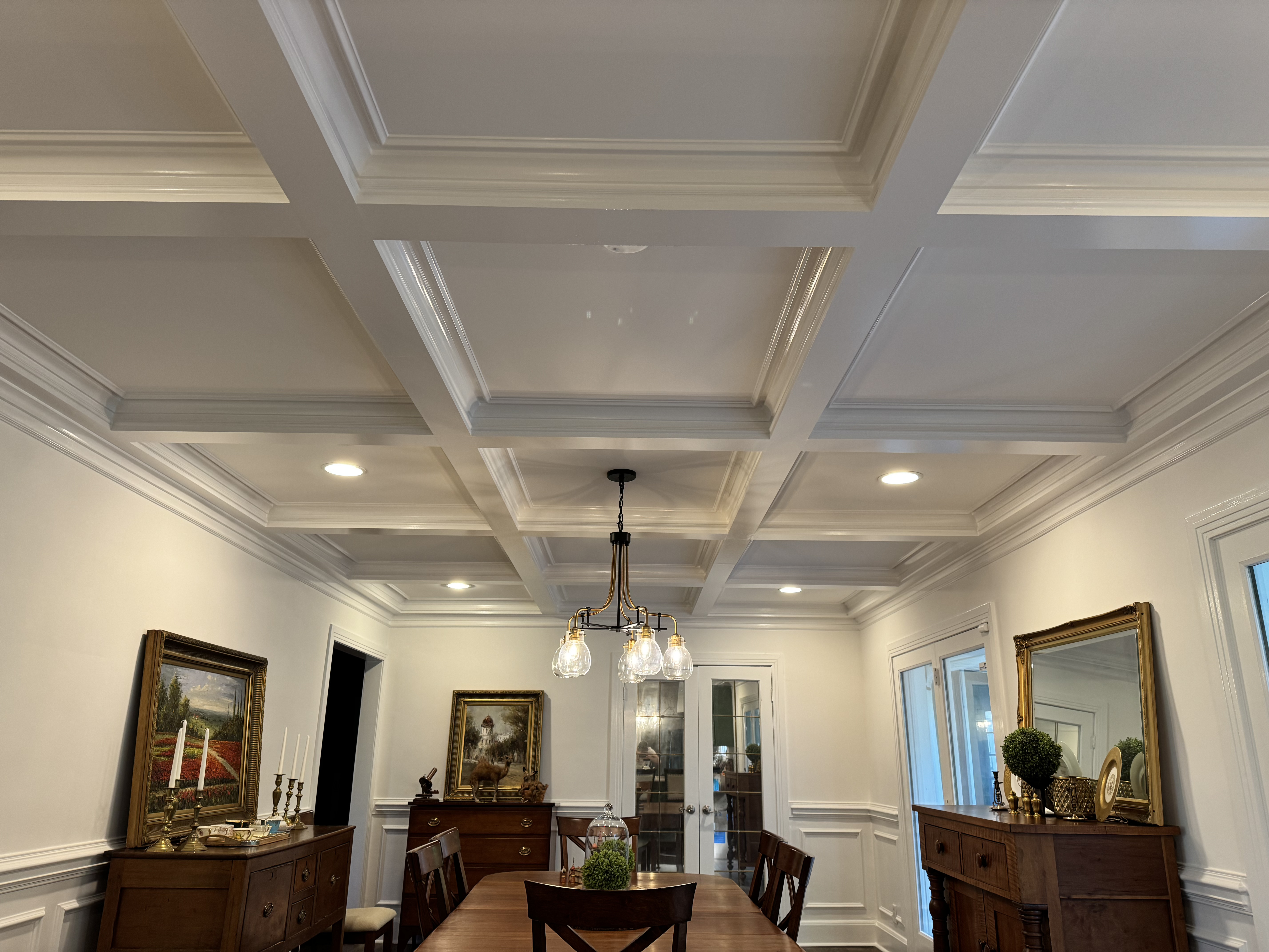 Elegant dining room with a custom white coffered ceiling and finish carpentry